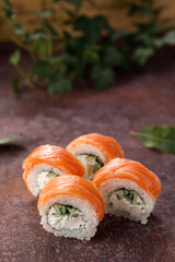 Philadelphia roll sushi on textured background still life. Restaurant concept. Close-up.