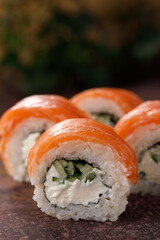 Philadelphia roll sushi on textured background still life. Restaurant concept. Close-up.