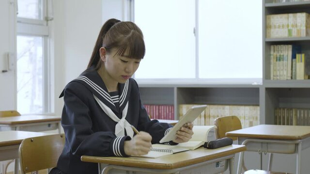 Young Japanese student studying in the classroom
