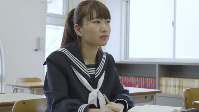 Young Japanese student studying in the classroom
