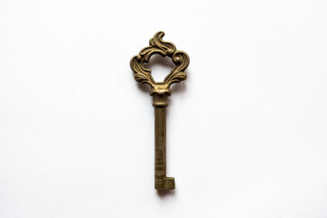Vintage brass key on a white background.