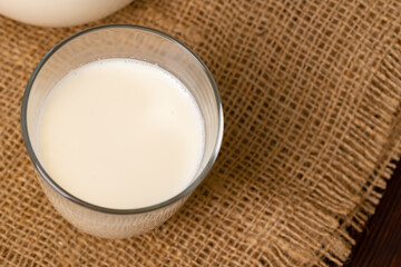 Glass cup of milk on table close up