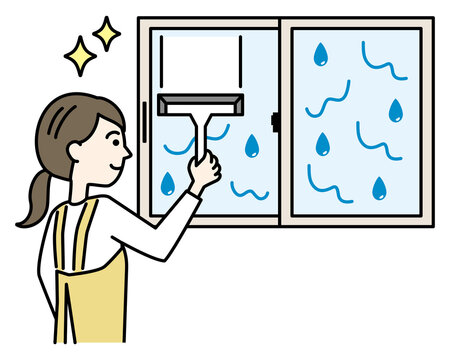 結露で濡れた窓をワイパー・スクイジーで掃除するエプロンの女性
