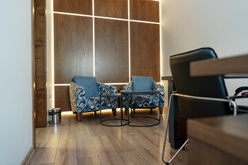 Office waiting area with arm chairs and coffee table