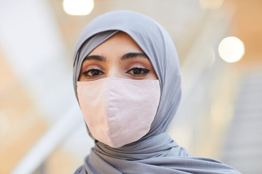 Close Up Portrait Of Modern Middle-Eastern Woman Wearing Mask And Headscarf While Posing In Shopping Mall, Copy Space