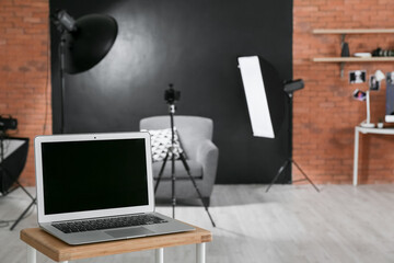 Modern laptop in photo studio