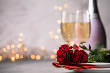 Valentines day table setting  red roses and champagne glasses on concrete background. Valentine 's greeting card - Image
