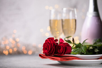 Valentines day table setting  red roses and champagne glasses on concrete background. Valentine 's greeting card - Image