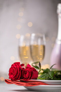 Valentines day table setting  red roses and champagne glasses on concrete background. Valentine 's greeting card - Image