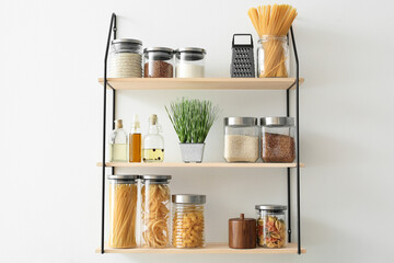Set of jars with products on kitchen shelves