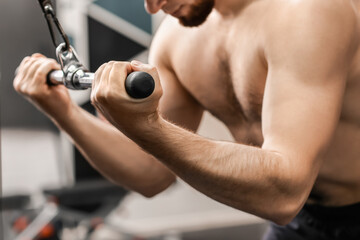 Fototapeta na wymiar Handsome muscular man training in gym