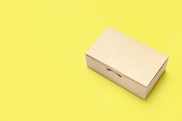 Blank cardboard box on color background
