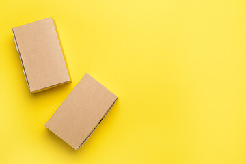 Blank cardboard boxes on color background
