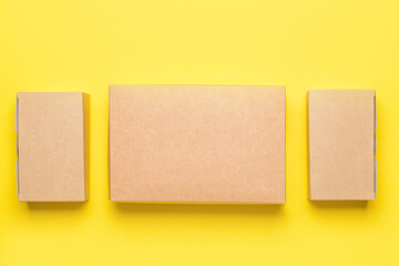 Blank cardboard boxes on color background