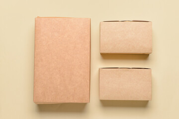 Blank cardboard boxes on color background