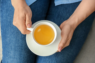 Woman with cup of green tea, closeup