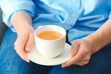 Woman with cup of green tea, closeup