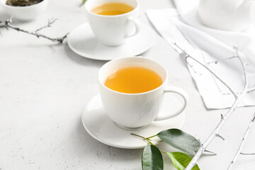 Cups of green tea on table