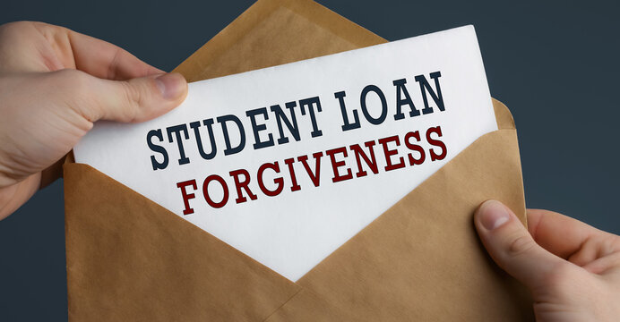 Male hands holding craft envelope with text STUDENT LOAN FORGIVENESS on blue background