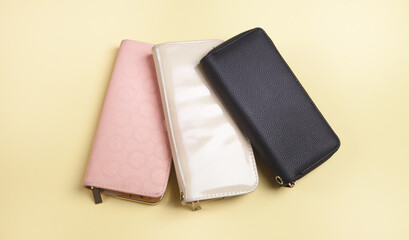 Womans wallets on an isolated yellow background.