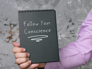 Lifestyle concept about Follow Your Conscience with phrase on the page.