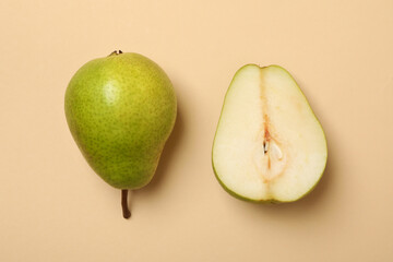 Fresh green pears on beige background, top view