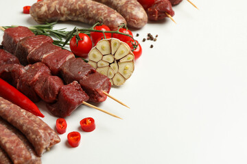 Set of different raw barbecue meat on white background, space for text