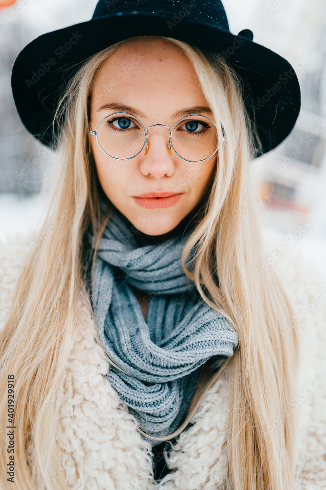 Wall mural Portrait of pretty stylish blonde girl in hat and glasses