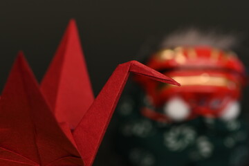 Red origami crane and Lion dance on black background