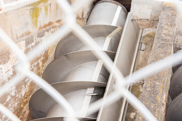 A screw conveyor at a sewage treatment plant