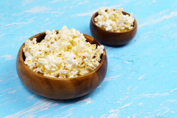 two Blue dish full popcorn. Selective focus. Home family watching movies. copyspace
