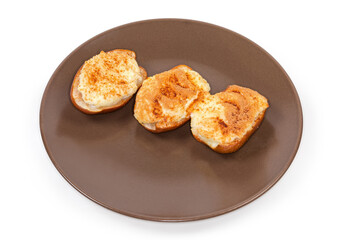 Baked pears with ricotta cheese and cinnamon on brown dish