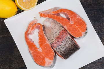 Top view of uncooked trout pieces on square dish