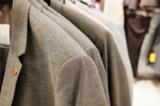 Men casual jackets hang on coathangers at showroom