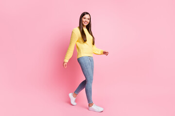 Fototapeta na wymiar Full size profile side photo of young beautiful attractive smiling positive girl go walk take step isolated on pink color background