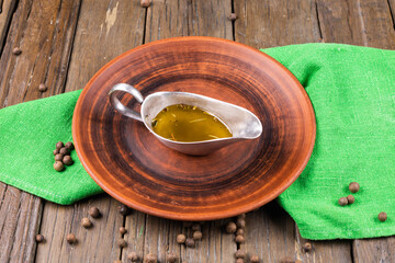 Bowl of mustard on wooden background