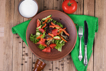 Salad from fresh vegetables in ceramic bowl