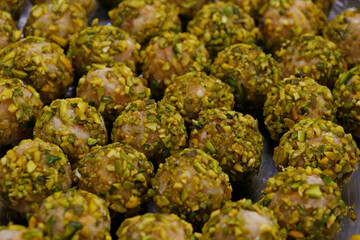 Fototapeta na wymiar pistachio rolled vanilla flavored energy balls in close up