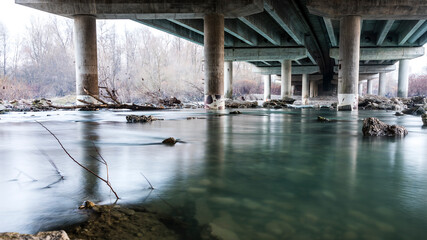 Ljubljana, Slovenia - 12 17 2020: River Sava flowing under a highway bridge in Ljubljana