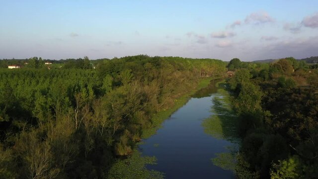 A video shot at sunset between the long trees with a drone in Sakarya Karasu Lake which is in Turkey. It is a real natural beauty.