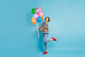 Fototapeta na wymiar Full length body size view of lovely cheerful girl holding in hand air balls having fun posing isolated over pastel blue color background