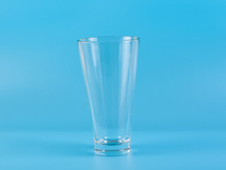 Glass with water aqua on blue background
