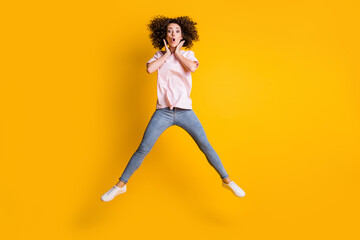 Fototapeta na wymiar Photo portrait full body view of shocked girl spreading legs with hands near face isolated on vivid yellow colored background
