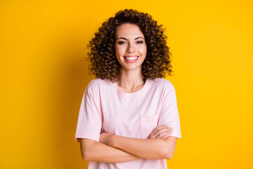 Photo of young attractive confident woman happy smile crossed hands isolated over yellow color...
