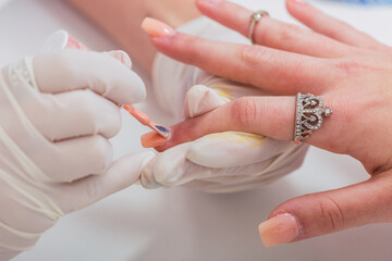 Professional manicurist beautifying a client's hands - Close-up of hands beautifying.