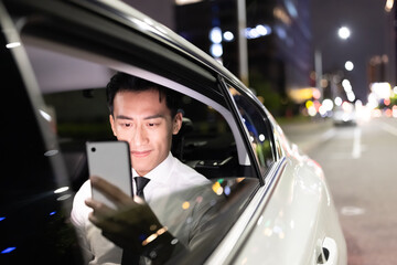 businessman use phone in car