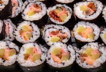 Top view of stack of Japanese sushi maki roll plate. Served in Japanese bar restaurant with chopstick