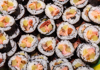 Top view of stack of Japanese sushi maki roll plate. Served in Japanese bar restaurant with chopstick