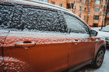 Snow covered car wing. Snowy winter season for motorists