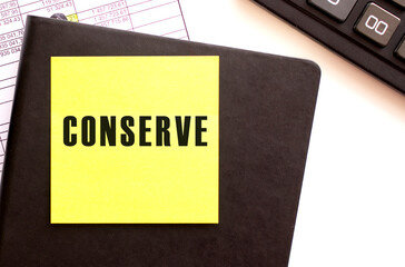 CONSERVE text on a sticker on your desktop. Diary and calculator.